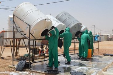 Disinfecting Water Tanks with Chlorine in the Za’atari camp in Jordan. Source: ACTED (2016)